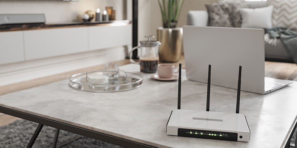 A router and a laptop on a table.