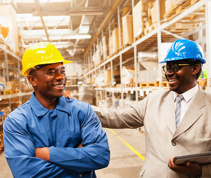 Two men in a warehouse.