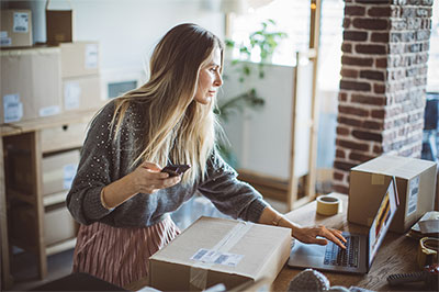 woman preparing package for shipment