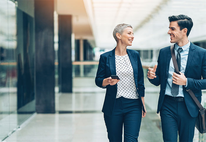Business associates walking and laughing.