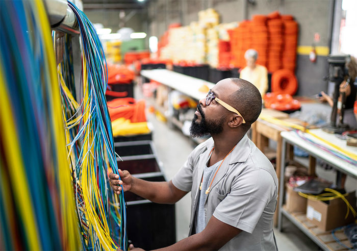 Networking professional aligning network cables.