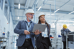 two workers having a discussion in a factory