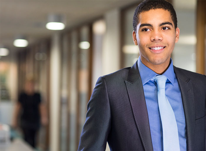 Young man in suit and tie in hallway.