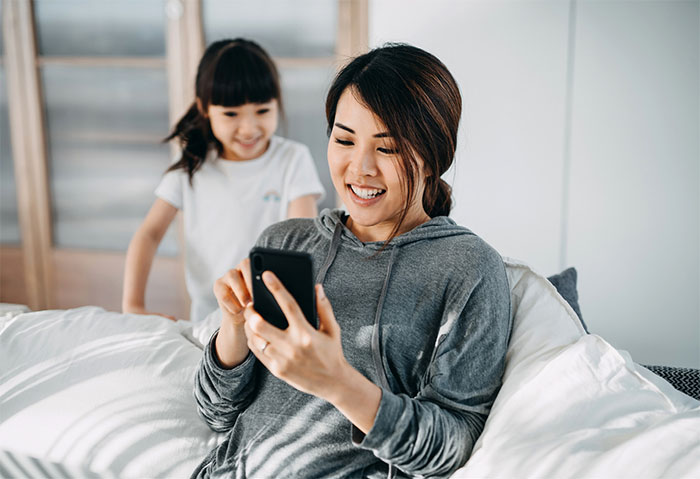 Mother scrolling through her phone