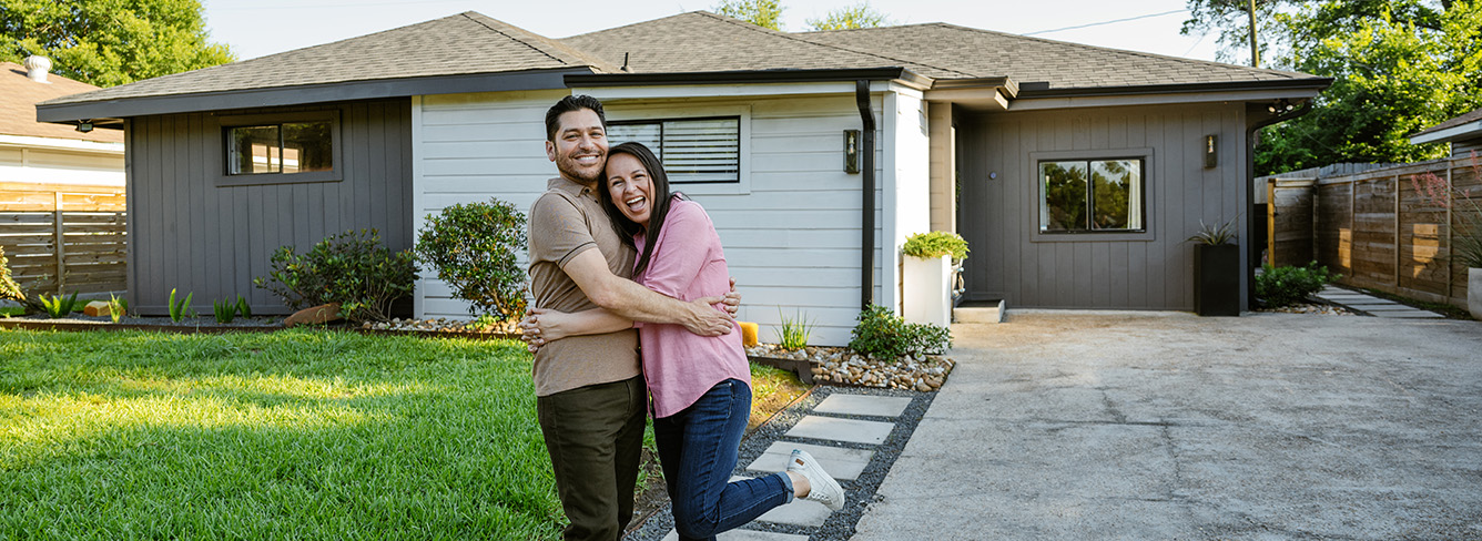 couple in front of their new home