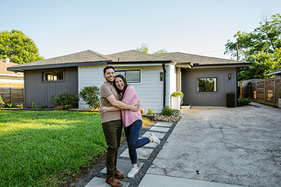 couple in front of their new home