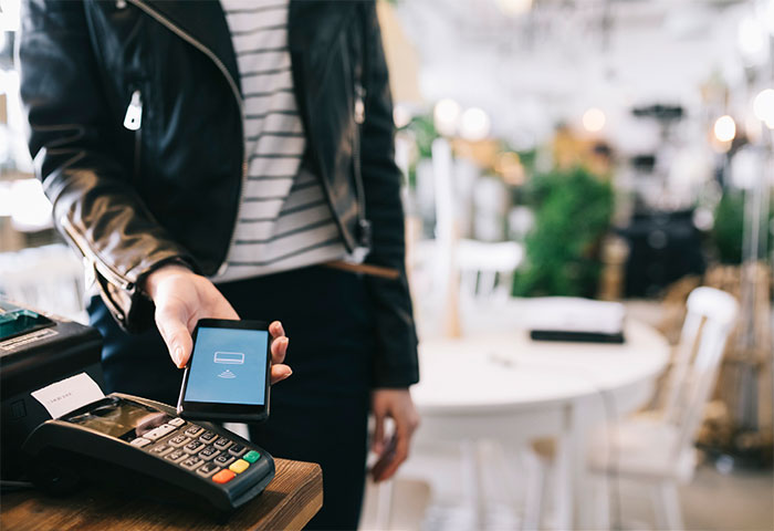 Man using smartphone mobile wallet to pay 