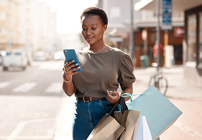 Woman checking her phone while shopping
