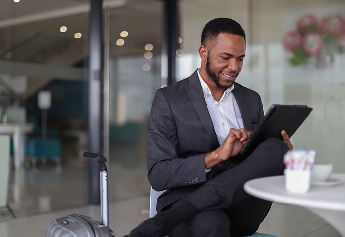 Businessman using tablet computer at a cafe.