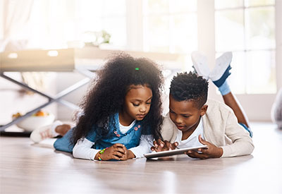 Siblings looking at a tablet
