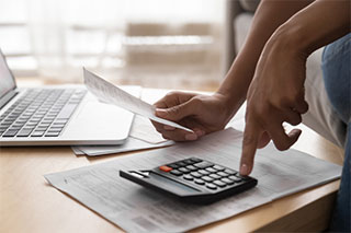 Adding up totals with calculator.