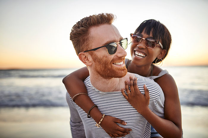 Couple hugging on the beach.