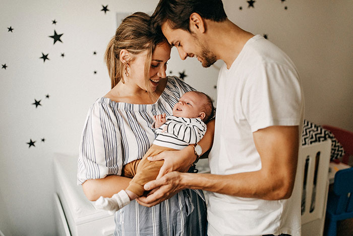 Couple holding their young son.