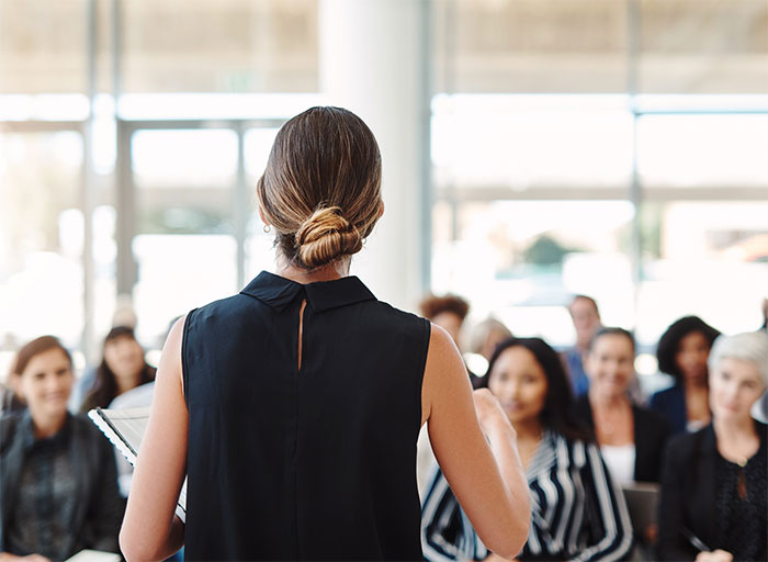 Woman speaking to a crowd.
