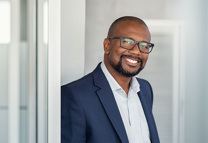 Smiling businessman with glasses.