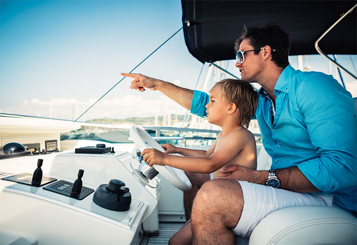 Father and son driving a boat