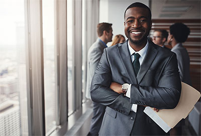 Smiling man wearing a suit and tie.