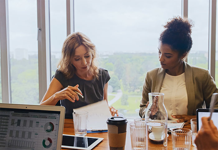 Female colleagues going over notes