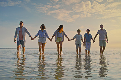 Family holding hands on the beach
